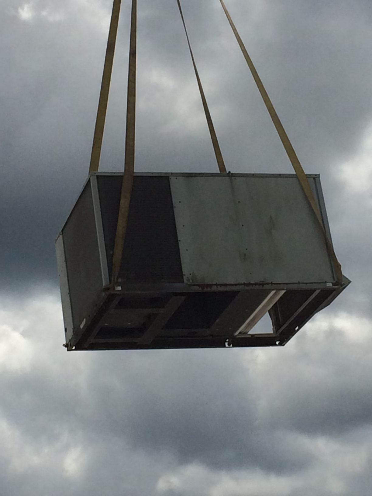Commercial HVAC system lifted during a Hudson Air project, pictured on its public website