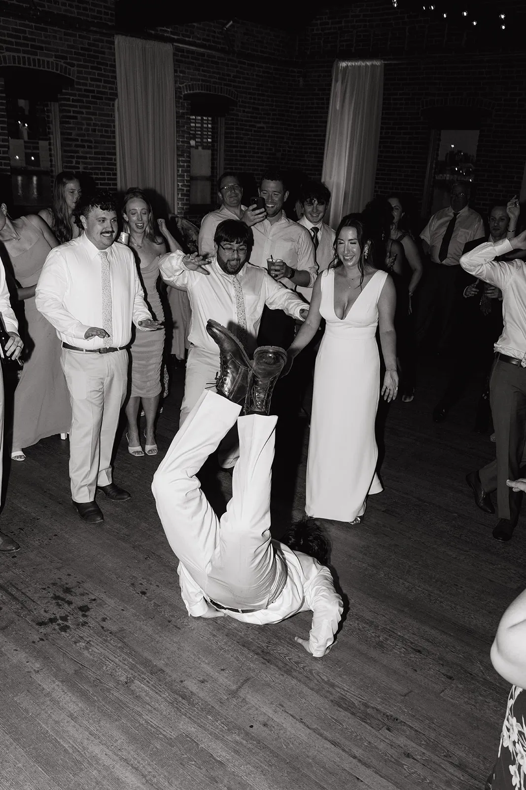guy doing the worm in front of bride