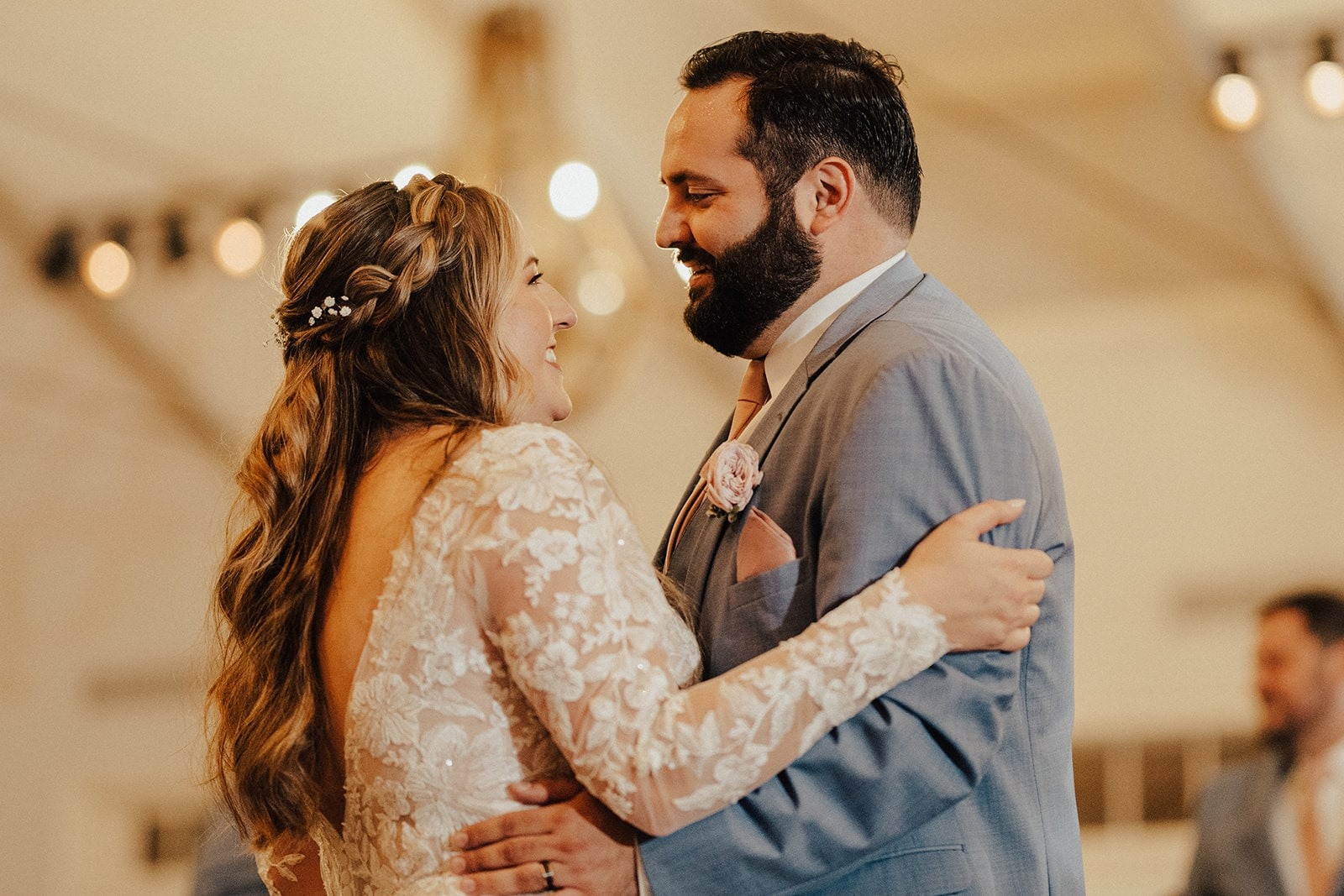 bride and groom smile during their first dance