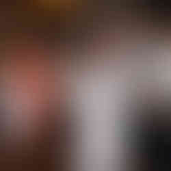 bride in party dress dances with groom behind her