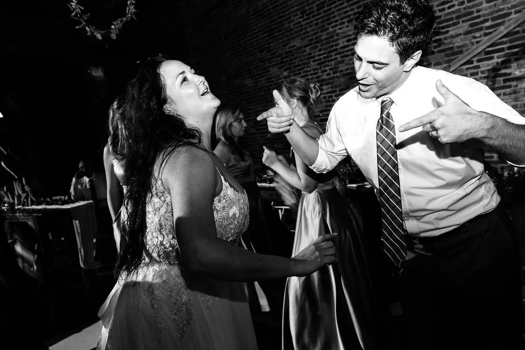 bride and guest dancing at wedding