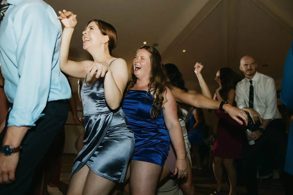 women dancing in a row at wedding