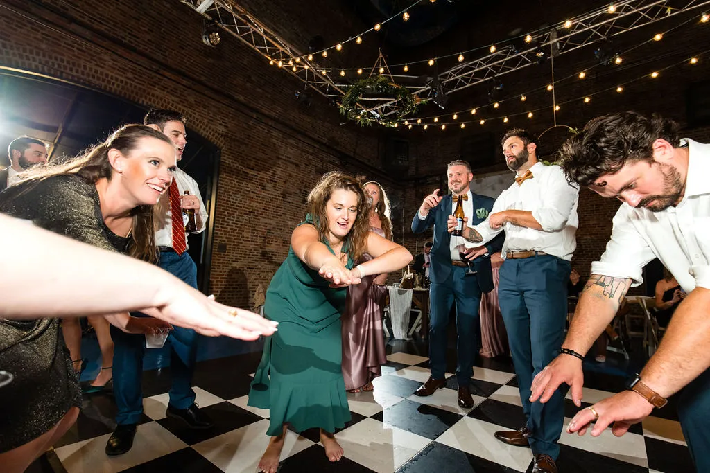 wedding guests dancing with hands outstretched