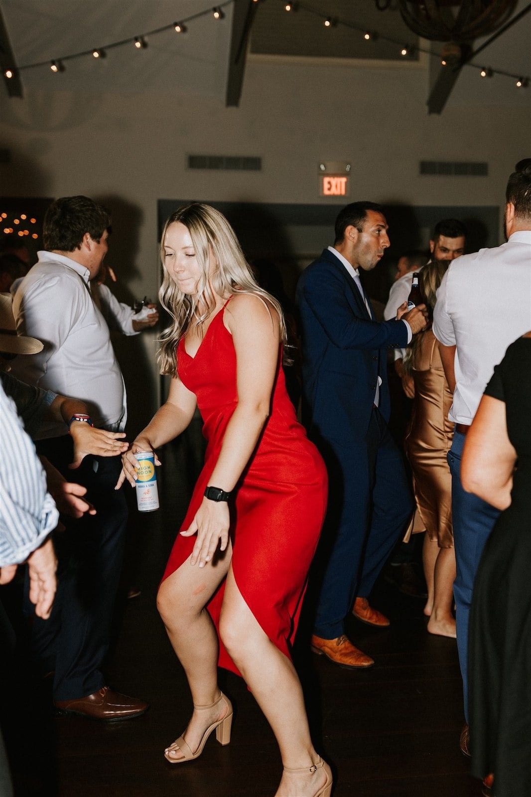 woman in red dress dancing at wedding