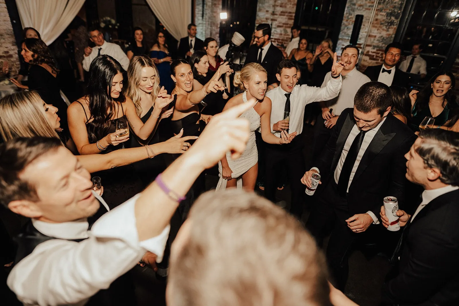 bride and guests dancing at wedding