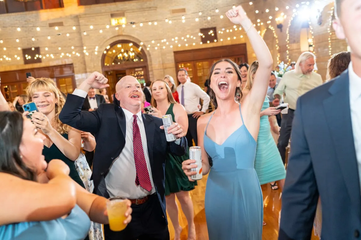 wedding guests dancing with hands up