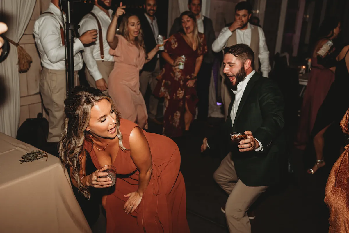bridesmaid bent over dancing with guy behind