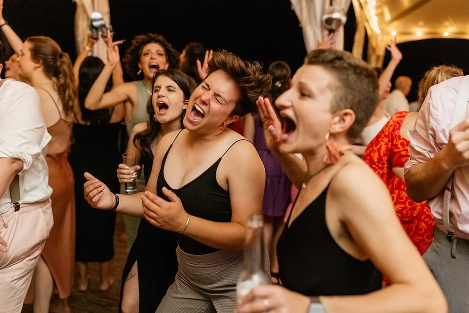 women dancing and singing at wedding