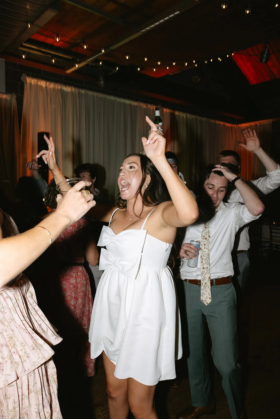 bride dancing with hands up