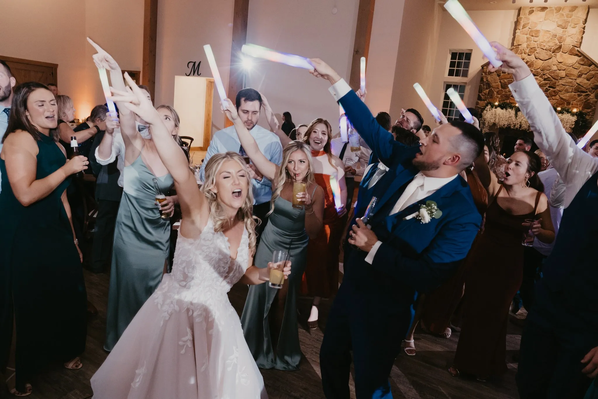 guests and bride dancing with hands up