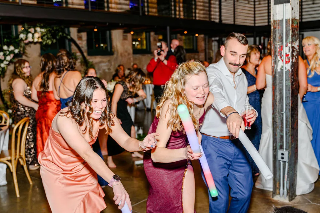 three young guests dancing at wedding