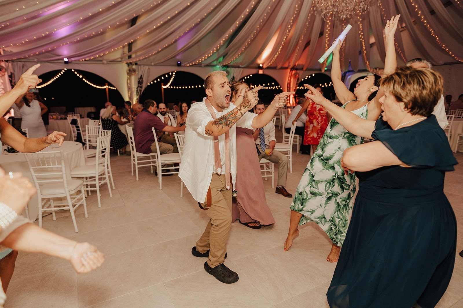 groomsman and guests dance together