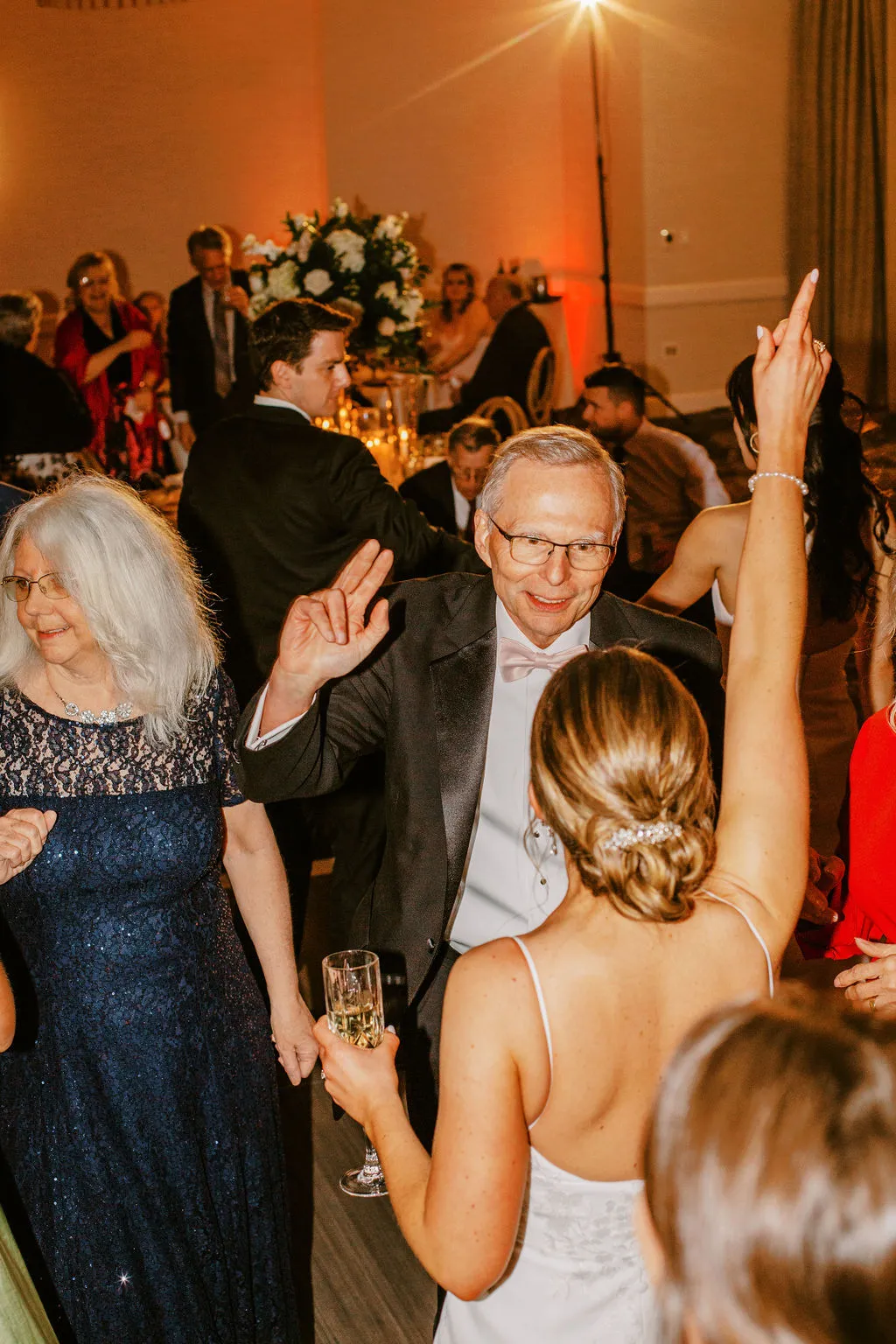 older man dancing with bride