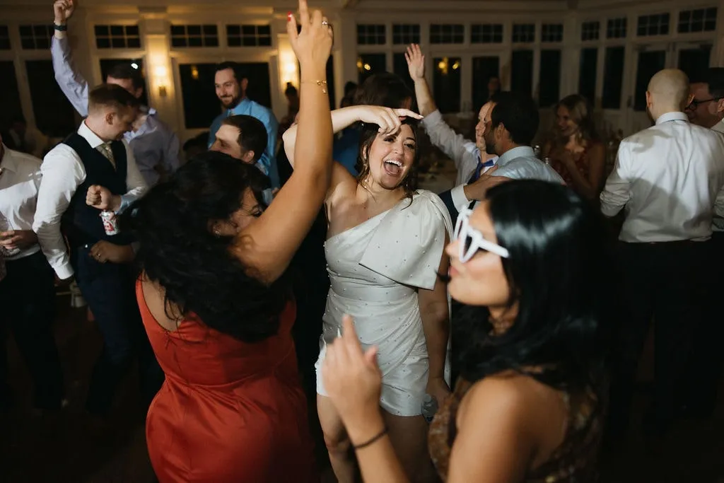 bride dancing at wedding with friends
