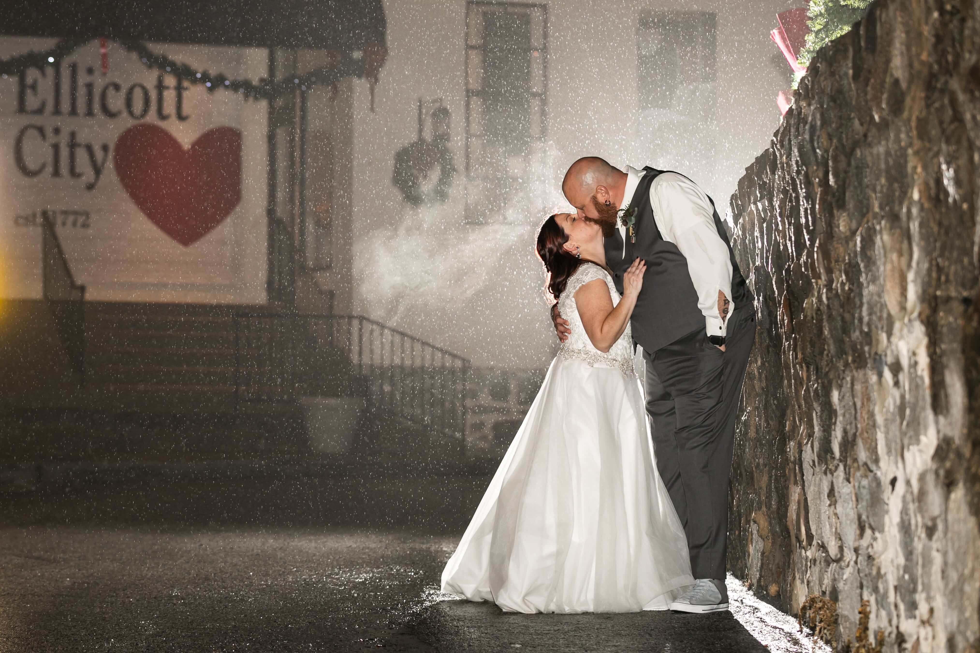 bride and groom kiss outside