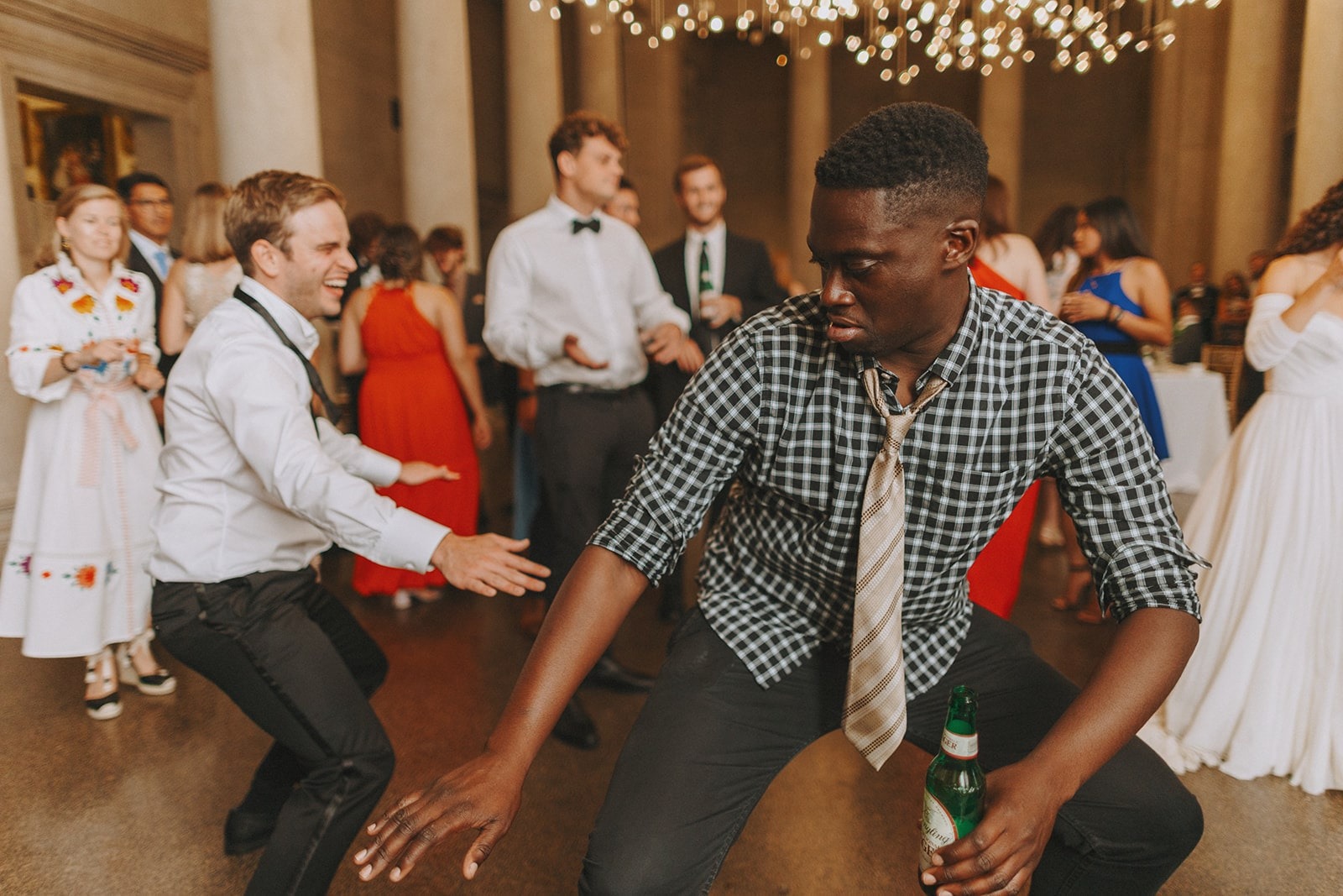 guy in checkered shirt dancing at wedding