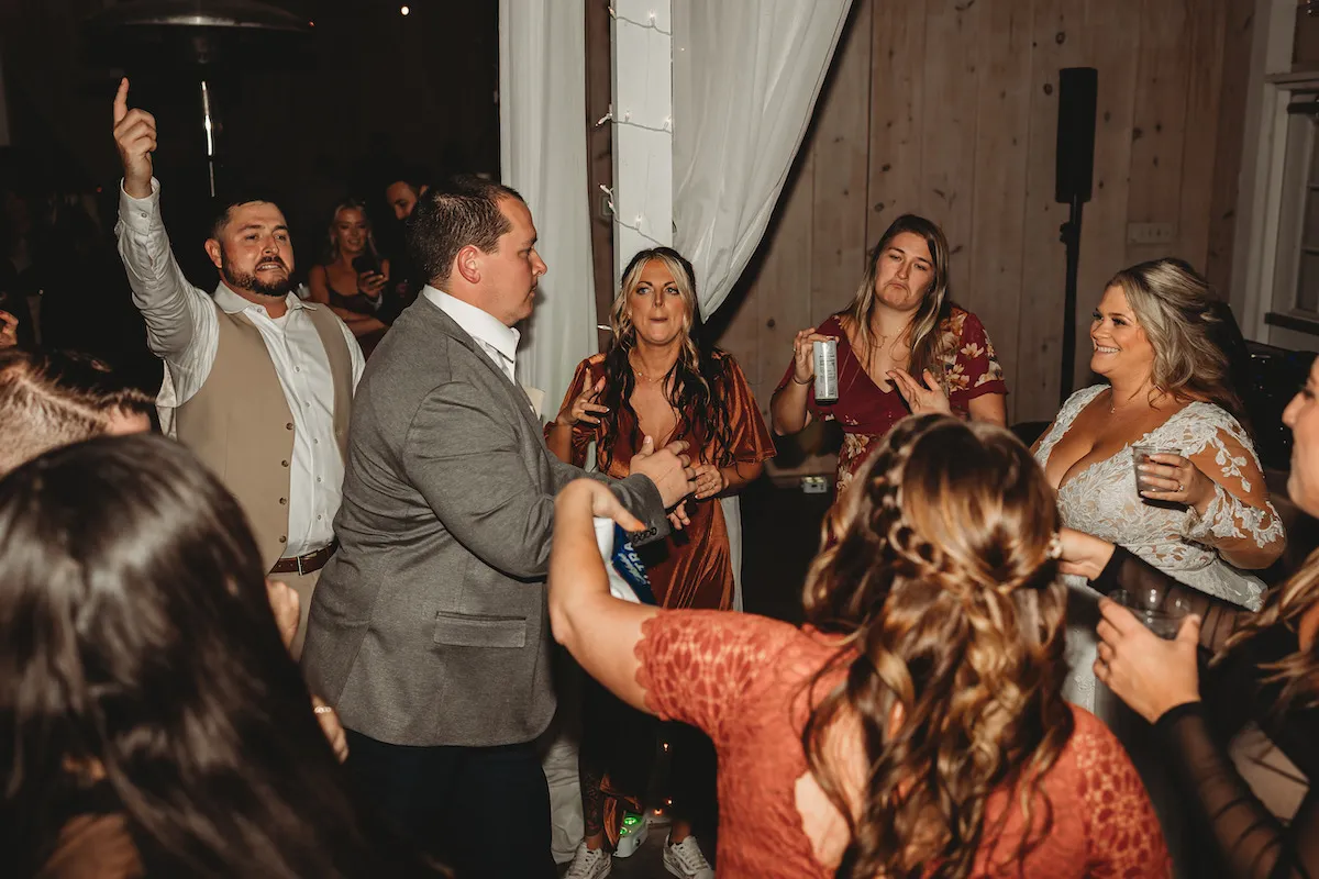 guy dancing in front of bride