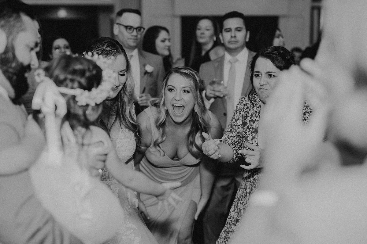 woman smiling while dancing at wedding