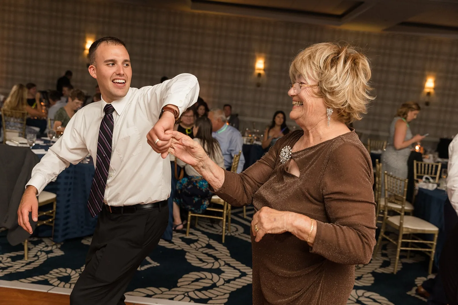 man spinning woman on dance floor