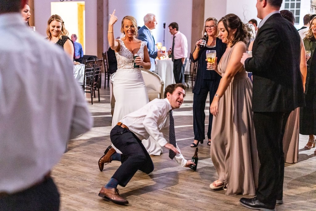 guy dancing with hand on the floor at wedding