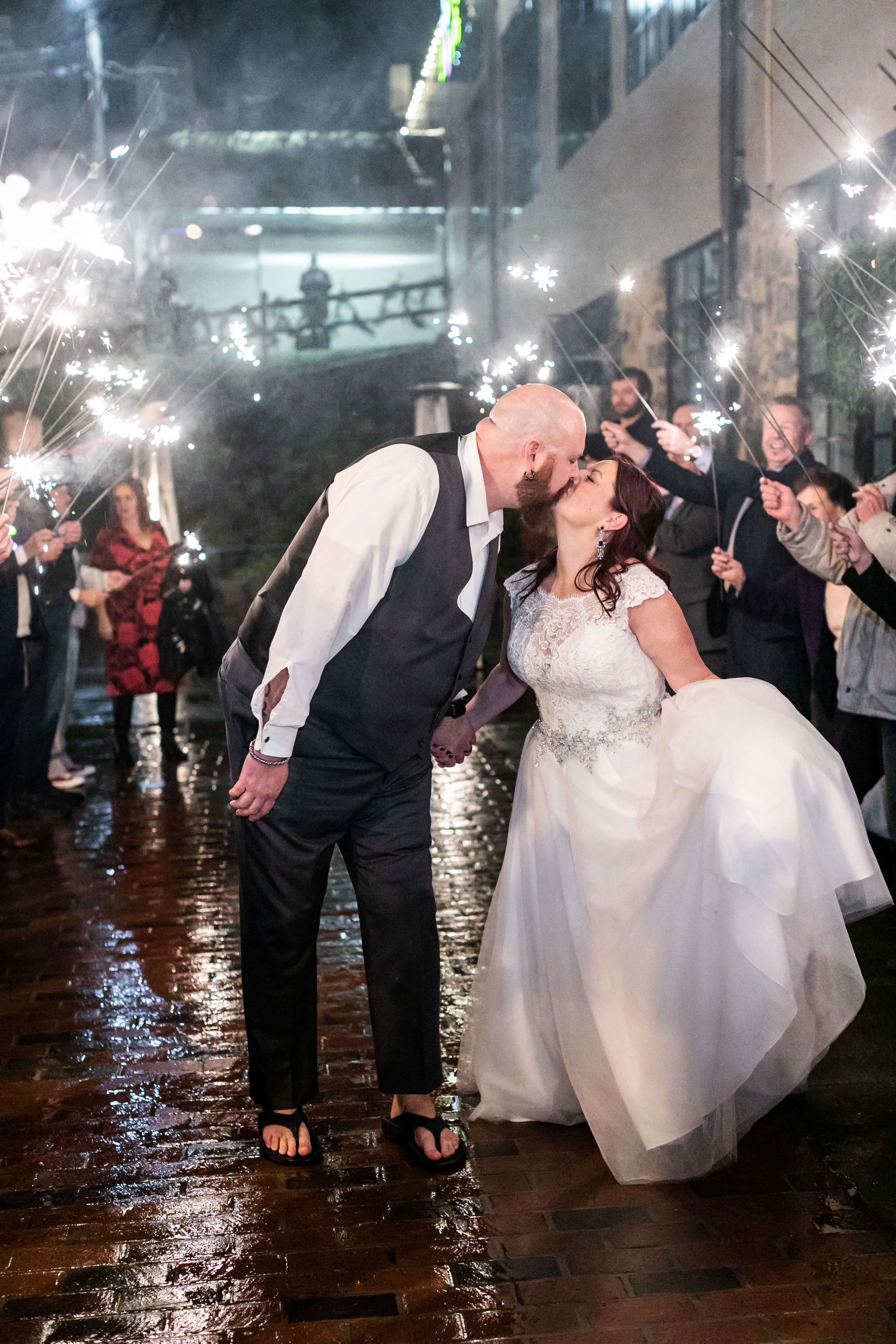 bride and groom kiss during sparkler exit