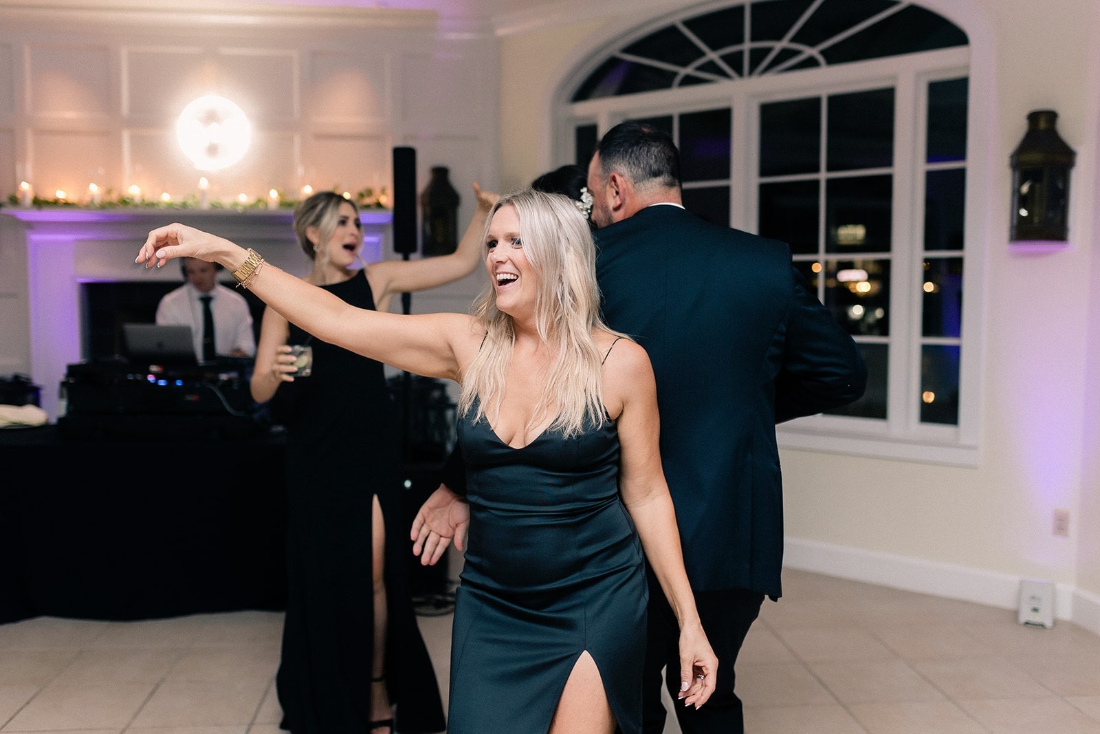 blonde in black dress dancing at wedding