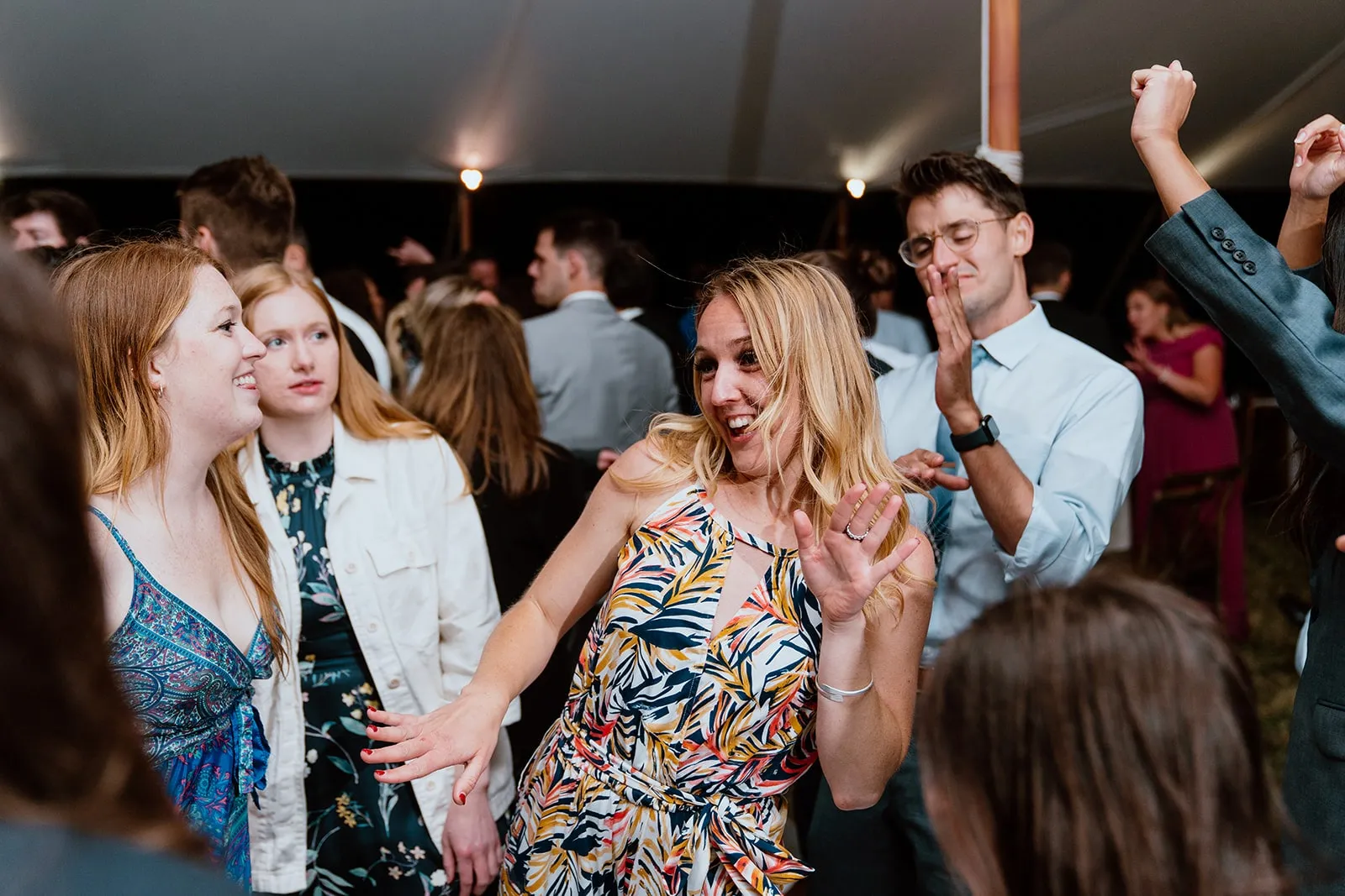 woman in patterned dress dancing at wedding