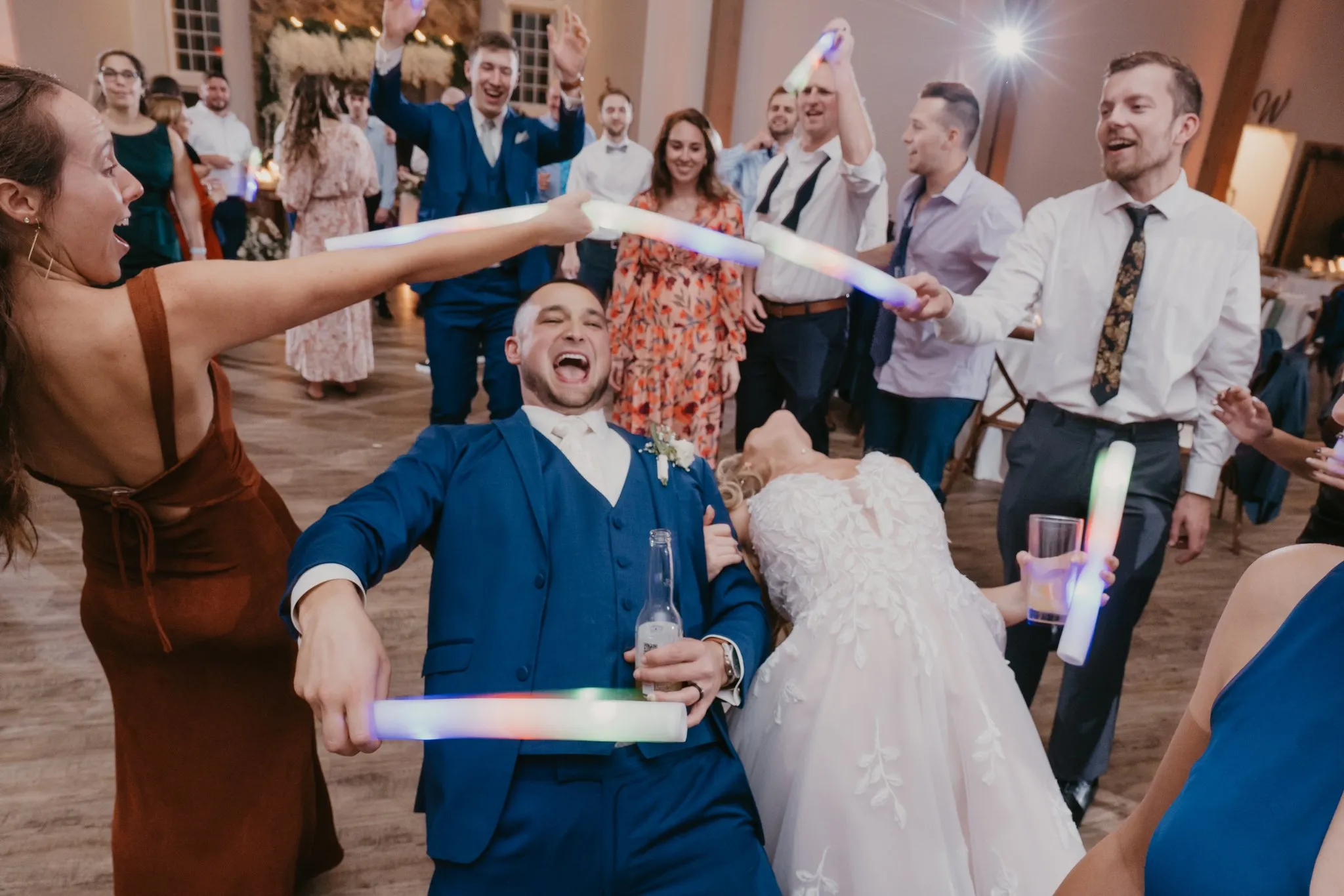 guests doing limbo at wedding