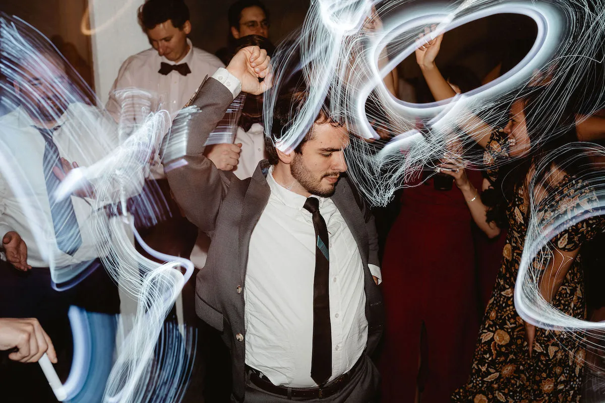 guy in grey suit and black tie dancing