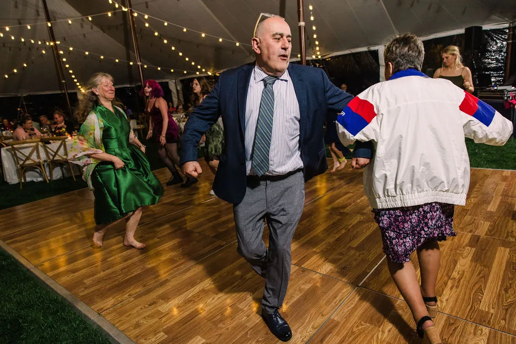guy arm in arm with woman dancing at wedding