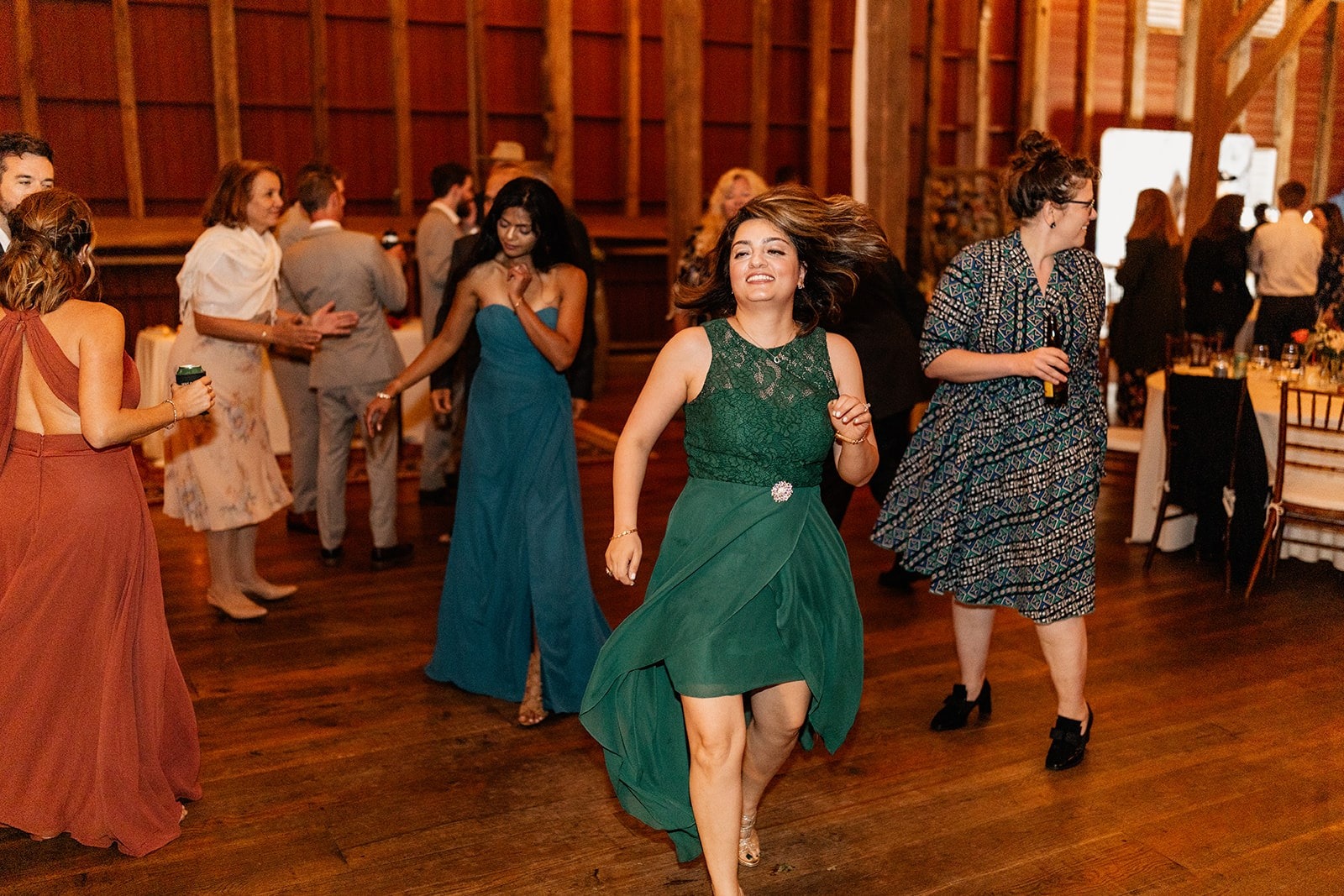 woman in green dress dancing at wedding