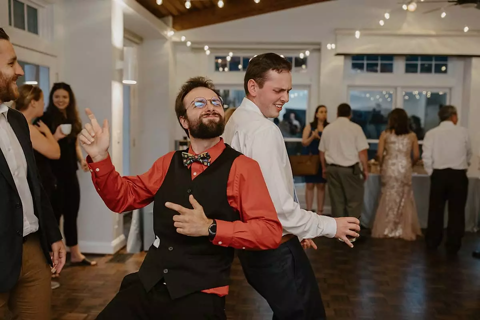 two men dancing back to back at wedding