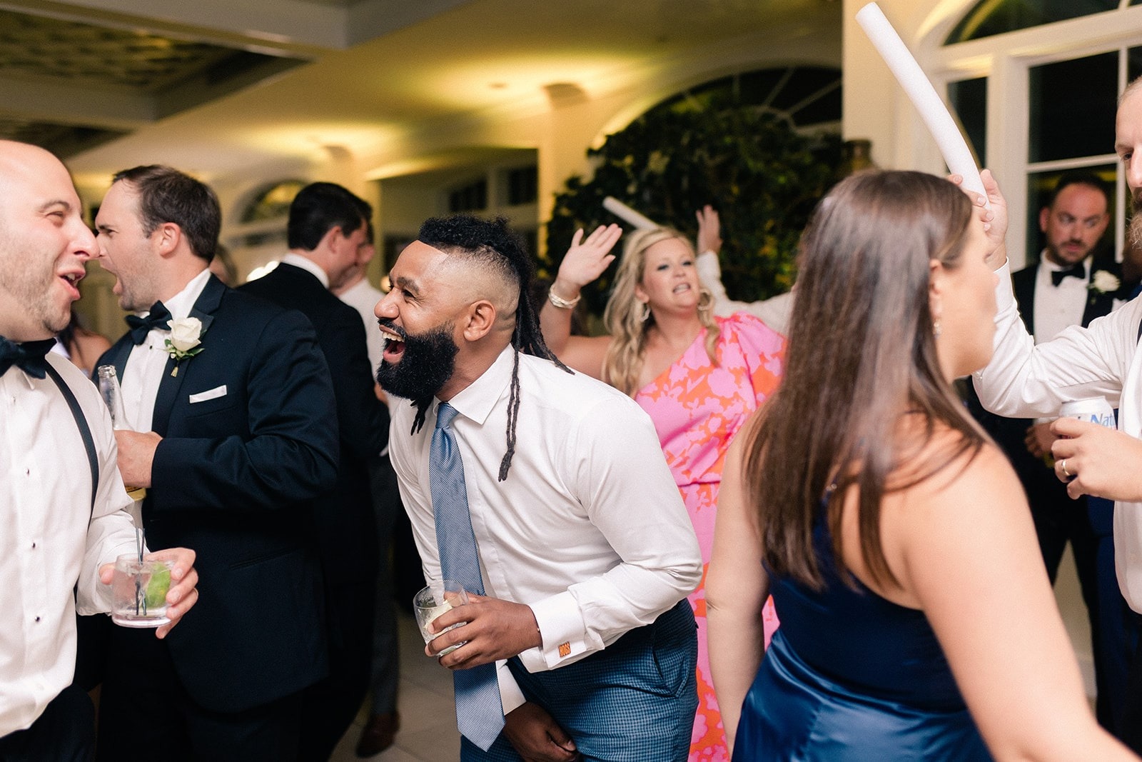 guy in blue tie dancing with wedding guests