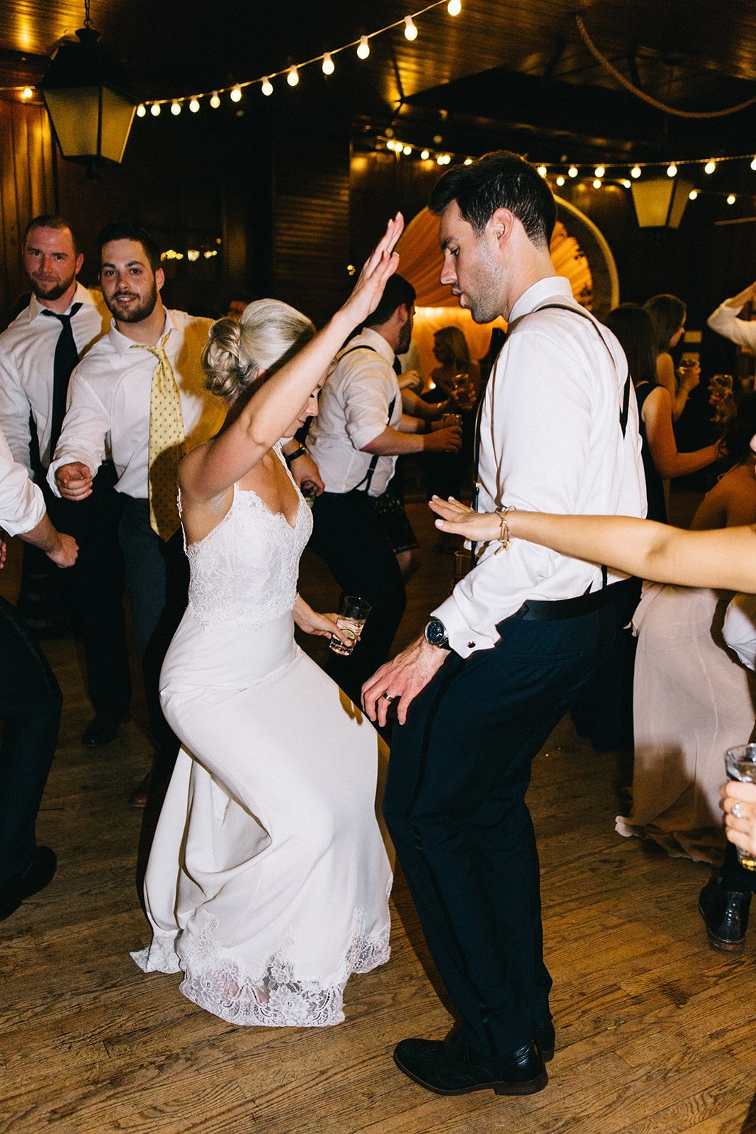 bride dancing with groom and guests