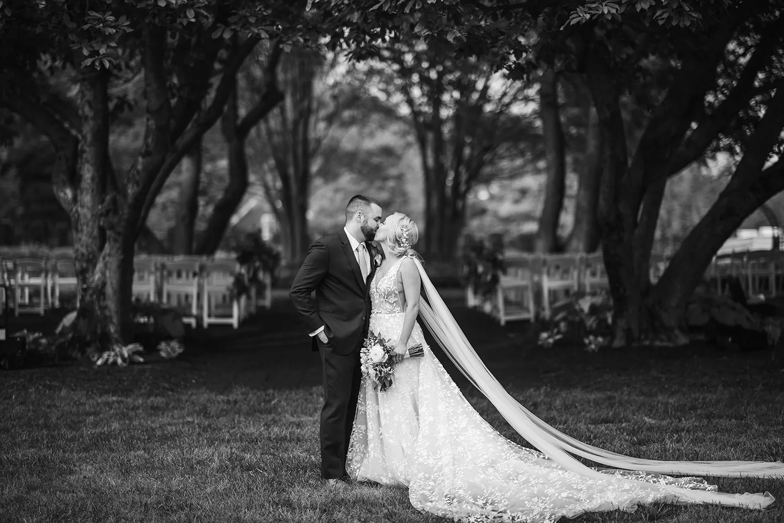 bride and groom outside in front of trees