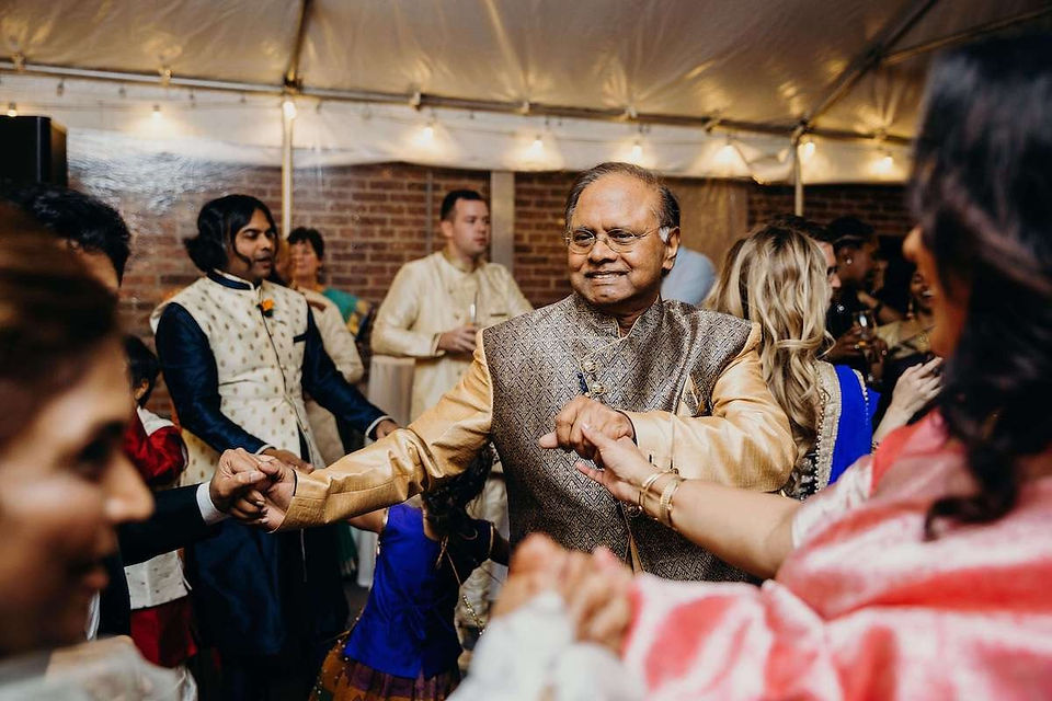 older indian man dancing at wedding