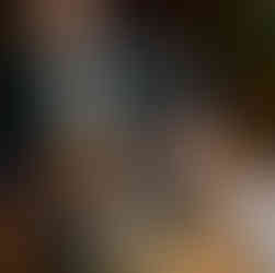 guy sits on shoulders of another guy at wedding