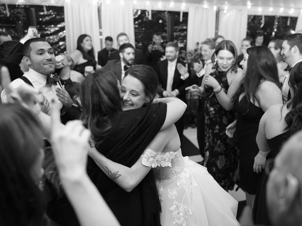 bride hugging woman while dancing
