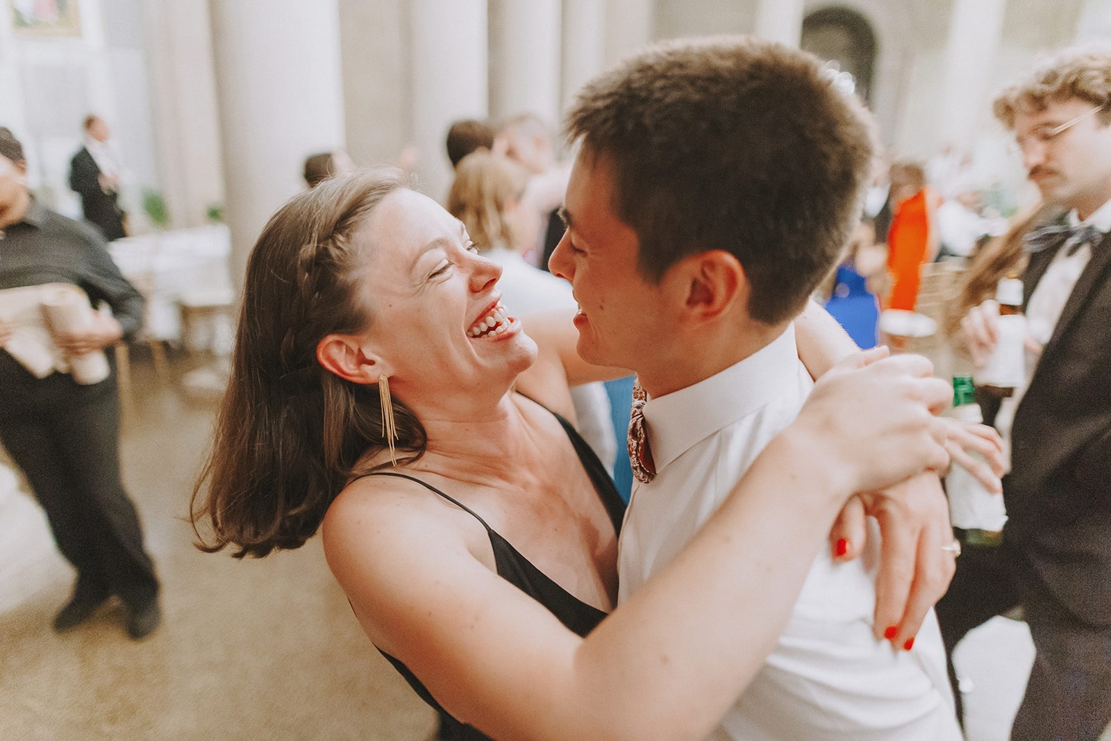 young couple dancing and smiling at wedding