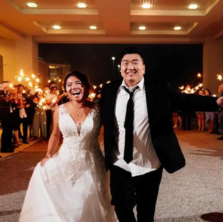 bride and groom smile during sparkler exit