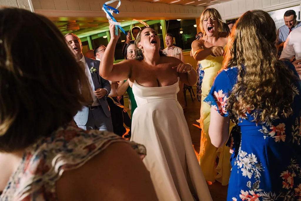 bride dancing and singing with guests