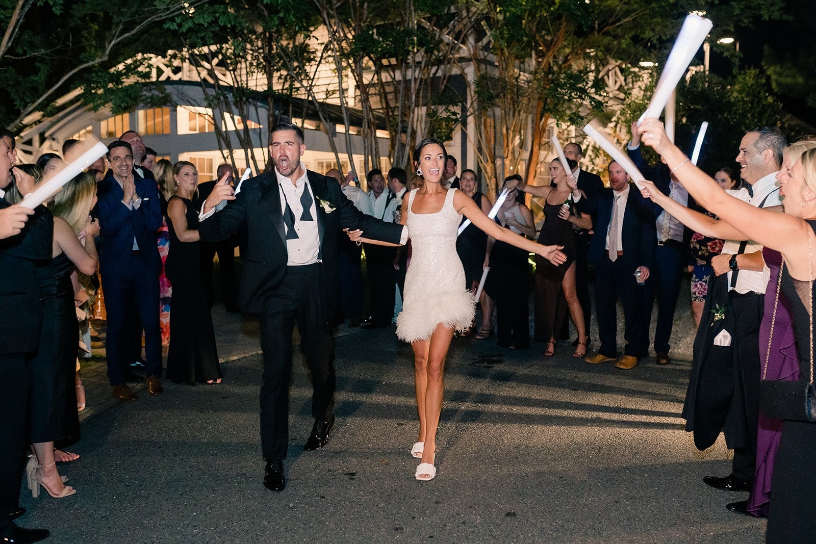 bride and groom exit surrounded by guests