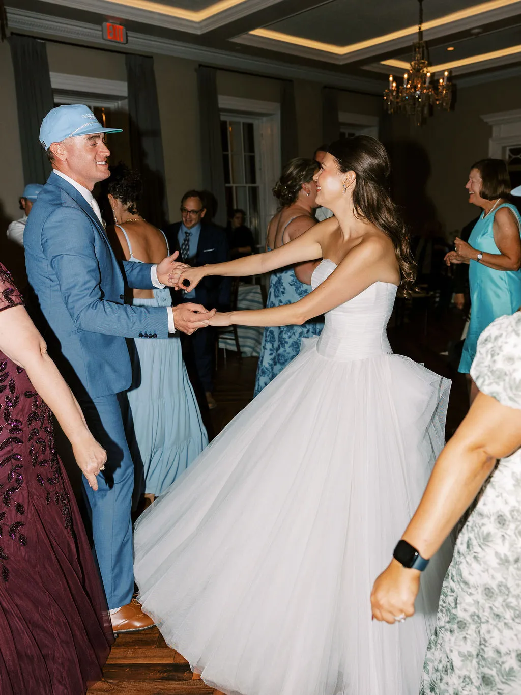 bride and groom dancing while holding hands