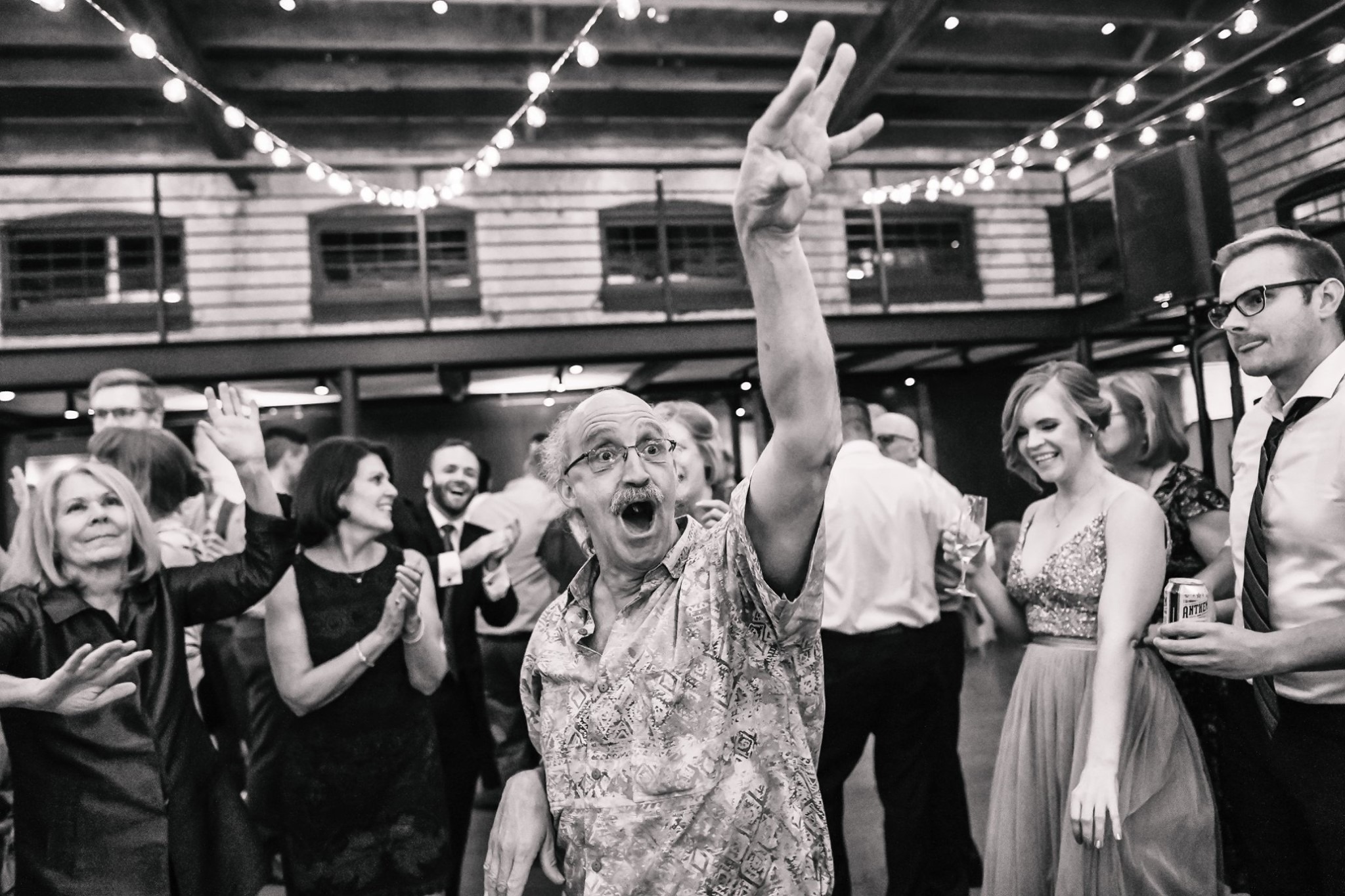old guy dancing at wedding with hand up