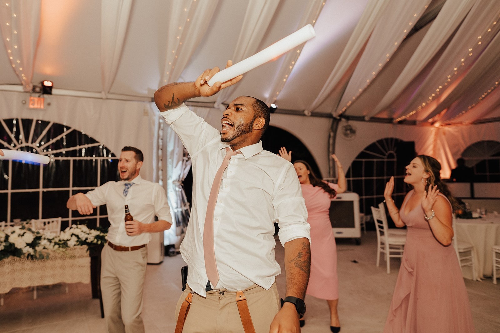 groomsman dances with hand up