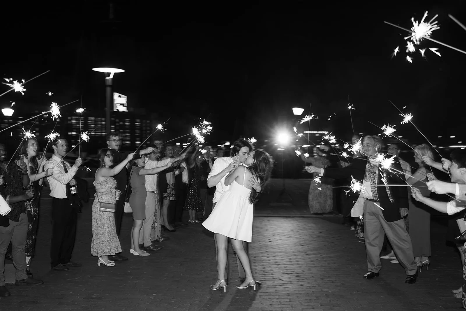 bride and groom kiss during sparkler exit