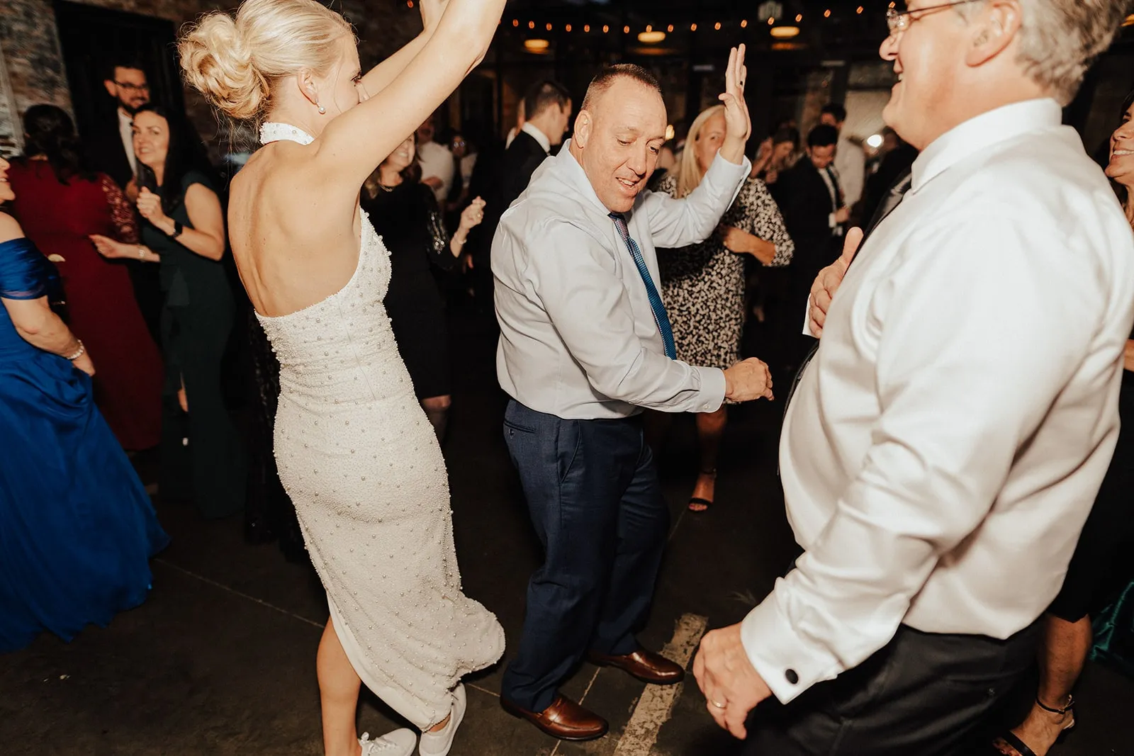 bride dancing with older man in front of her