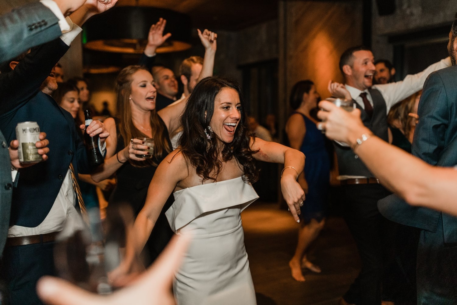 bride dancing and smiling with guests