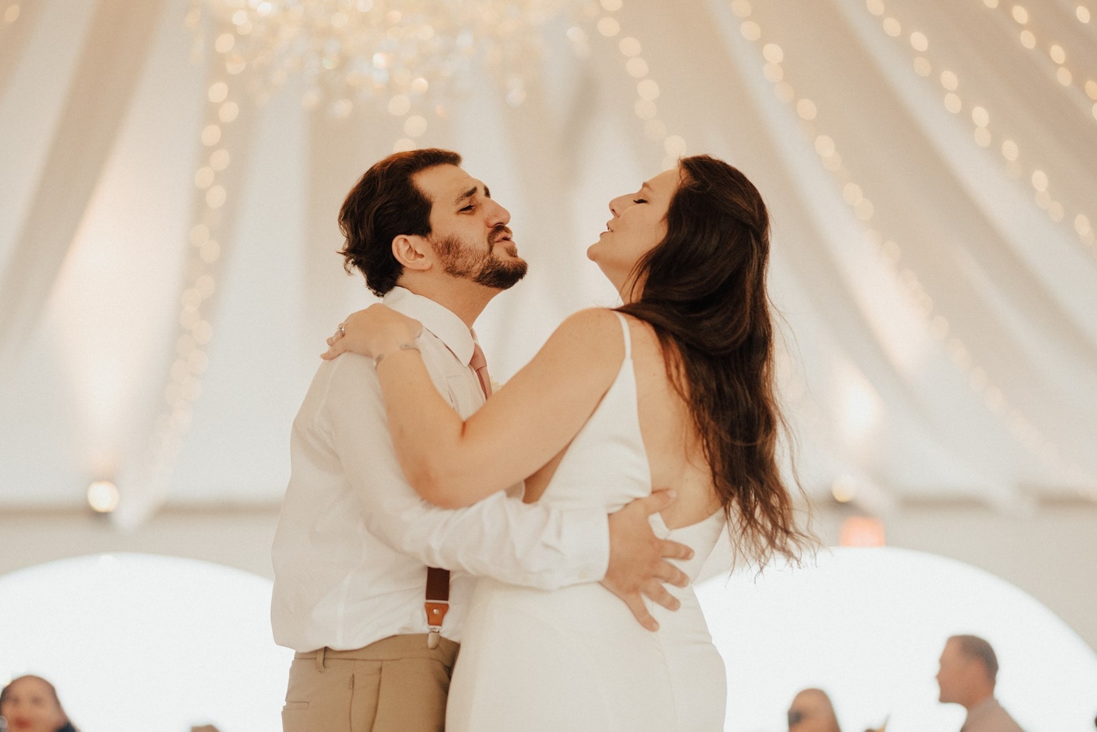 bride and groom first dance in tent