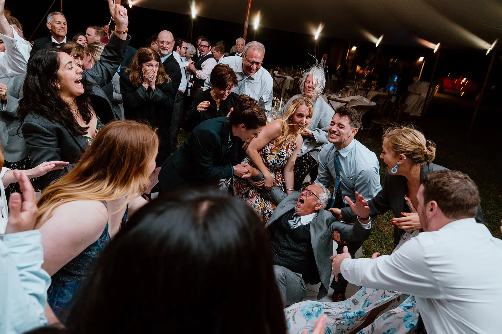 older man being lifted back up off of dance floor